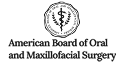 The image shows a logo with text that reads 'AMERICAN BOARD OF DENTAL SPECIALTIES' and beneath it, 'American Board of Oral Implantology and Maxillofacial Surgery.
